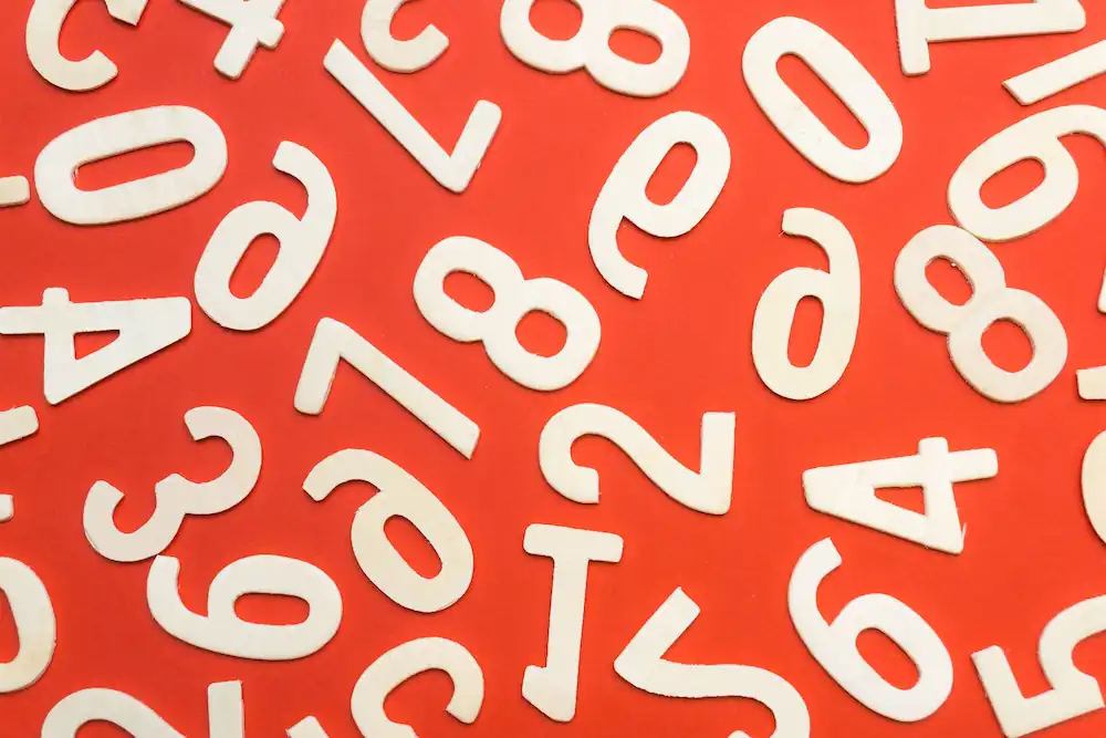 Ransom numbers and letter on a red background.