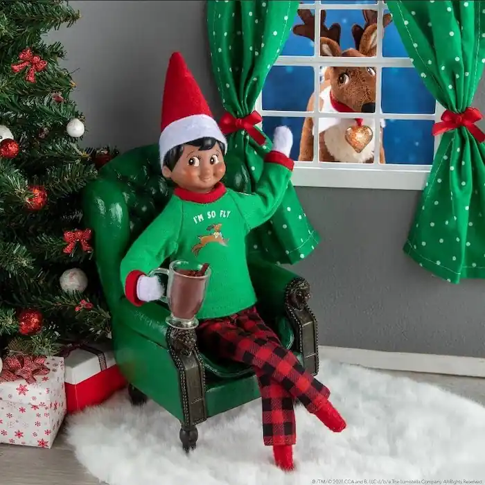 Scout elf doll getting cozy on a couch