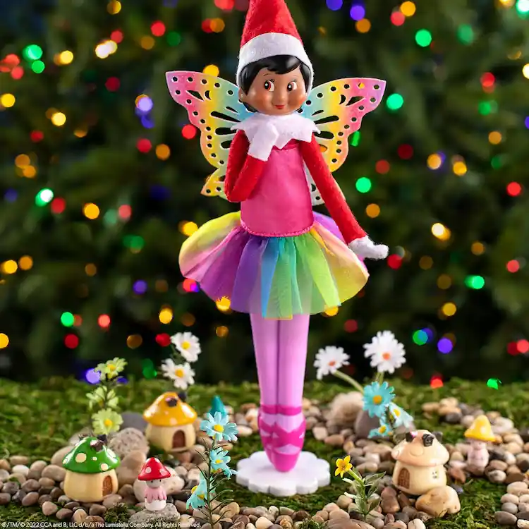 Scout elf doll wearing a glittery dress with a pair of wings.